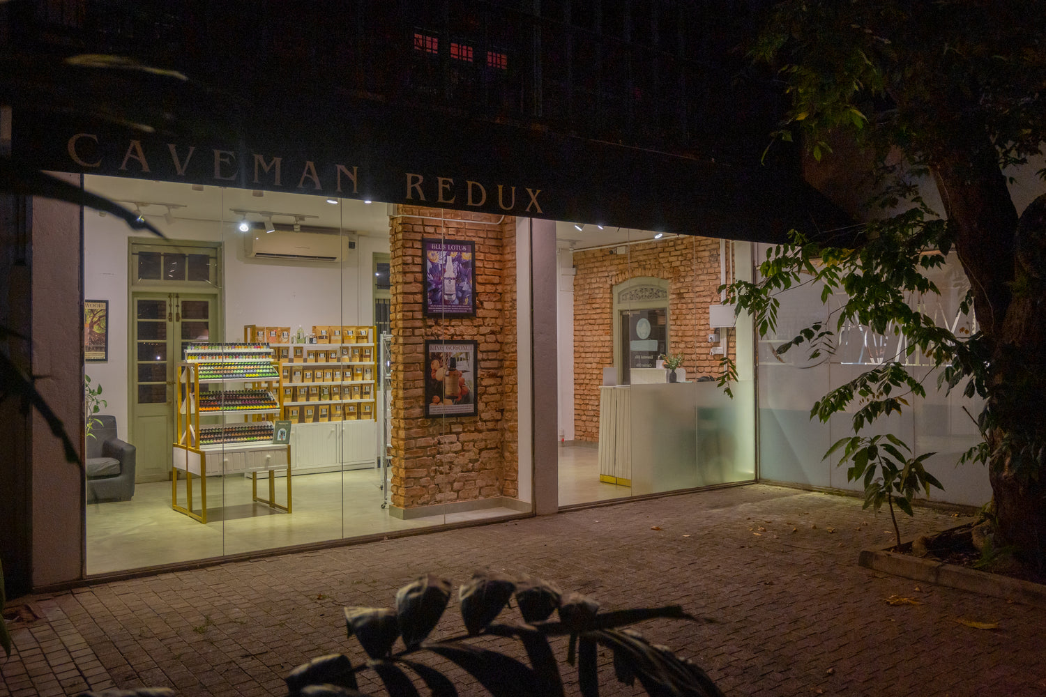Storefront of 'Caveman Redux' with interior visible through large windows.